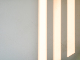 Sunrise drop shadow on old white concrete wall. 