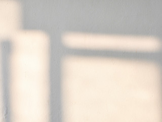 Sunrise drop shadow on old white concrete wall. 