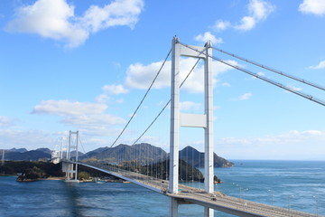 Stylish bridge across on the blue beautiful ocean in Japan