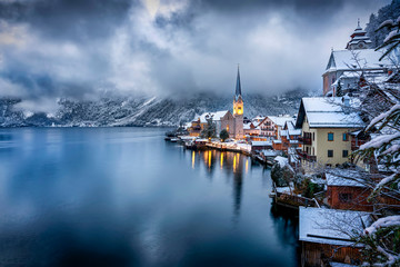 Das idyllische Dorf Hallstatt an einem Wintermorgen mir Wolken und tiefem Schnee, Alpen, Österreich