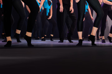 Legs of dancing people in a row in the dance hall salon. Dancing school activity