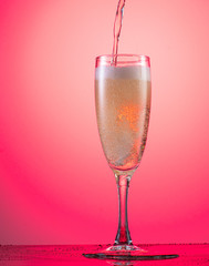 champagne glass with foam on a colored gradient background