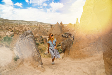 Woman traveller walking at the valley in Cappadocia, Anatolia, Turkey.