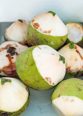 fresh young coconuts on a market