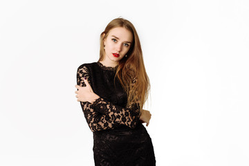 Sexy beautiful pensive girl in a black lace dress in the studio. Beautiful lady isolated on a white background