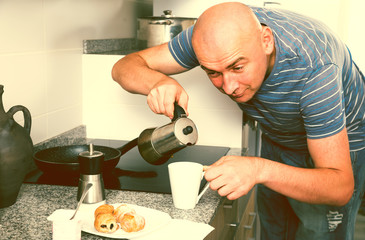 Naklejka na ściany i meble man preparing coffee in moka pot