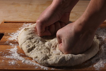 the process of rolling out the dough with your hands
