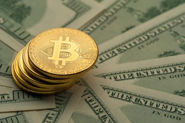 Close-up of golden Bitcoin coins lies on piles