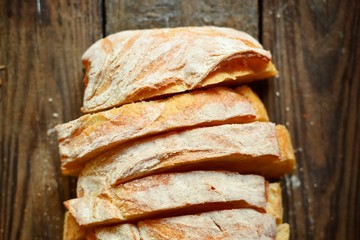 Beautiful sliced ​​bread on a dark background in flour. Bakery products. Top view, place for text. Assortment of bread.