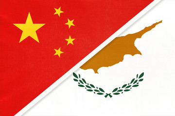 China or PRC vs Cyprus national flag from textile. Relationship between asian and european countries.