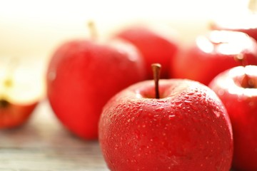 Red apples on a wooden background. Healthy ripe fruits, raw food diet, vegetarian.