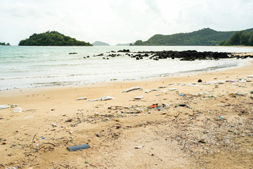 Fototapeta na wymiar Plastic bottles and other trash on sea beach