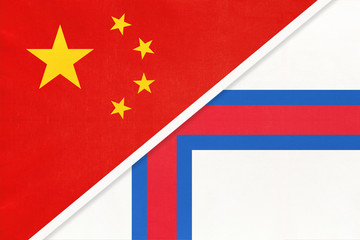 China or PRC vs Faroe Islands national flag from textile. Relationship between asian and european countries.