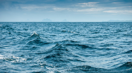 sea with waves and cloudy blue sky