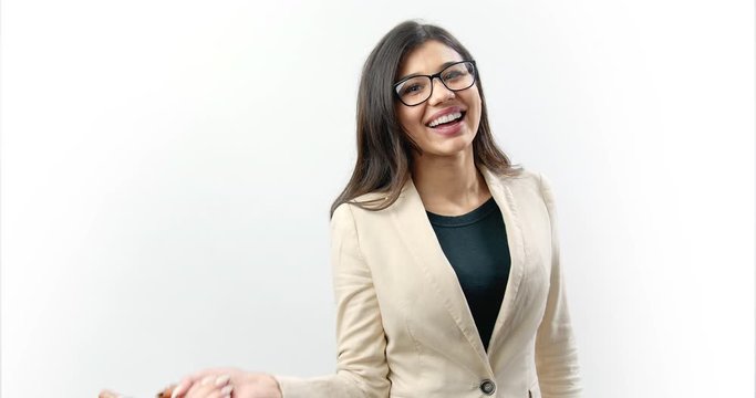 Charming young business woman with dark long hair wearing formal suit and eyeglasses smiling and posing on camera with leather brown handbag. Concept of business and finance