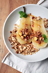 Poached pear with yogurt and  granola.