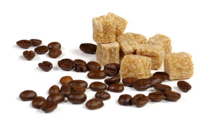 coffee beans and brown sugar cube on a white background