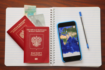 passport phone and world map on the table
