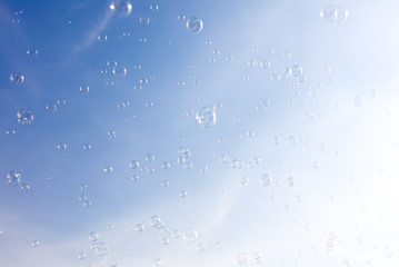 Soap bubbles fly in the blue sky - Powered by Adobe