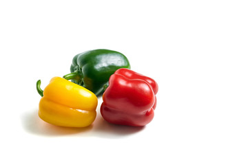 Red, green, and yellow bell peppers isolated on white background. Three sweet peppers in different colors, vegetable ingredient, healthy food