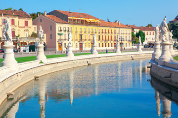Water canal with statues on square Prato della Valle in Padova