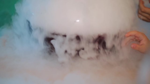 Children's animators carry out a scientific experiment with dry ice