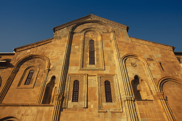 Fototapeta na wymiar Georgian Culture and Travel concept. Svetitskhoveli Cathedral in Mtskheta, Georgia. Sunny day with blue sky. Text space. Outdoor shot