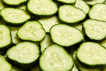 Sliced cucumber background. Many green circle slices of gherkin