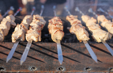 The meat on metal sticks is fried