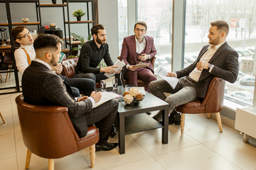 successful interaction of young leaders in tux gathered together for discussing business ideas and projects, developing new business startup, solving problems connected with deadlines