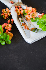 Vintage table setting with delicate flowers on a dark background