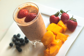 Strawberry smoothie with fruits on plate