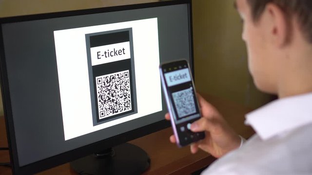 A man purchases a E-Ticket with QR code online for the event, travel, trip. Electronic ticket booking, buying, payment 