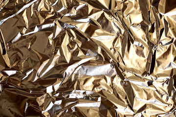 Texture of crumpled foil in silver color.
