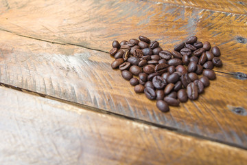 Coffee beans on wood background