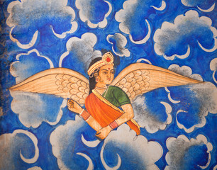 Winged Indian girl in sari flying in the sky - ancient wall painting at Patwon Ki Haveli in Jaisalmer, Rajasthan, India