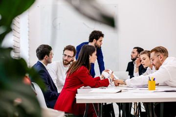 young caucasian business team co-working in office, friendly crew consisted of young enthusiastic...