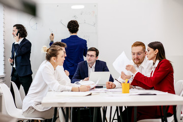 young business co-workers in office, discuss ideas and projects together with partners in modern office, successful interaction of diverse partners