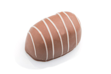 Single chocolate candy isolated on white background. side view.