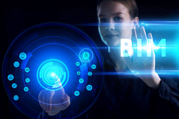 Business, Technology, Internet and network concept. Young businessman working on a virtual screen of the future and sees the inscription: BIM