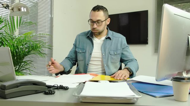 handsome man in office busy stressed headache paperwork burnout 4k 50frame footage