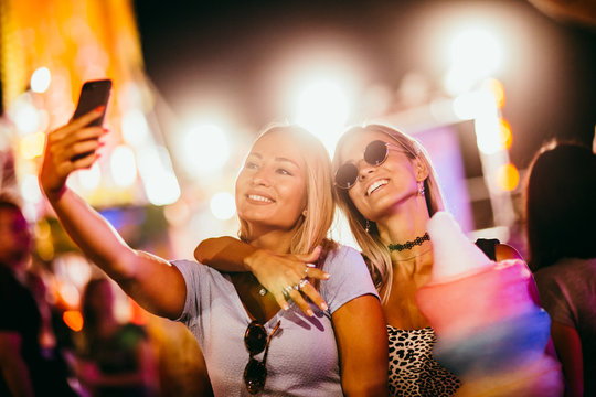two girls taking selfie at the music festival