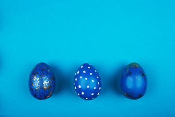 Easter eggs golden and blue design on blue background. Holiday