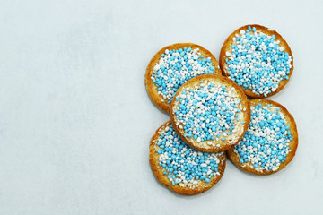 Rusk with blue and white anise seeds called beschuit met muisjes. Traditional Dutch tread to celebrate the birth of baby boy.