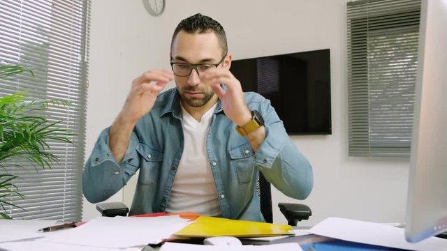 handsome man in office busy stressed headache paperwork burnout 4k 50frame footage