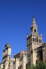 Fototapeta na wymiar Giralda bell tower of Seville Cathedral, the largest Gothic Cathedral in Europe