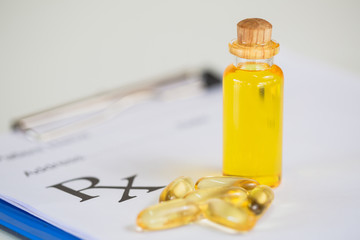 Hemp oil in a glass bottle Hemp seeds in a wooden spoon placed on the table. The concept of bringing hemp oil Extracted as a medicine By natural methods. The idea of planting seeds as seedlings.