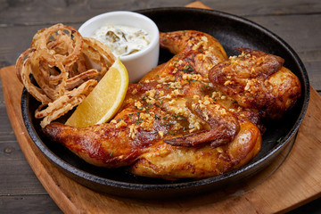 roasted chicken with sauce on the wooden background