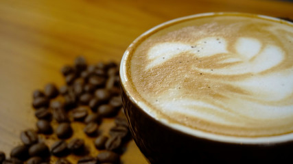 Coffee Latte with coffee beans scattered on the table