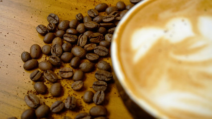 Coffee Latte with coffee beans scattered on the table
